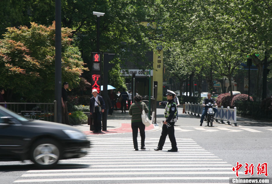杭州新招治“中國式過馬路” 路邊擺屏幕“現場直播”