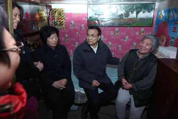 李克強(qiáng)考察棚戶區(qū):彎腰坐上高低床