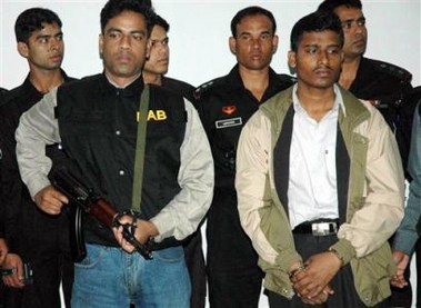Bangladesh Special Security Force soldiers guard Ataur Rahman, front right, military commander of Jamatul-Mujahideen in Dhaka, Bangladesh, Wednesday, Dec. 14, 2005.