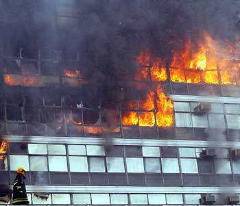 Brazilian fire workers combat fire at the government's social security archives building in Brasilia December 27, 2005. No victims were reported.