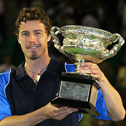 Marat Safin holds the 2005 Australian Open championship trophy after his win over Australia's Lleyton Hewitt in Melbourne in this January 30, 2005 file photograph.