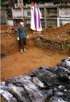 Standing in a light drizzle, the handful of mourners didn't know any of the 30 people laid side by side in a mass grave Sunday as workers began burying the few victims recovered since a mammoth mudslide wiped out this farming village.
