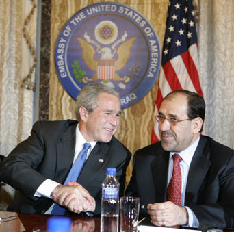 U.S. President George W. Bush (L) joins Iraq's Prime Minister Nouri al-Maliki, during an Iraqi Cabinet Meeting at the U.S. Embassy after Bush arrived in Baghdad for a surprise visit to the city June 13, 2006.