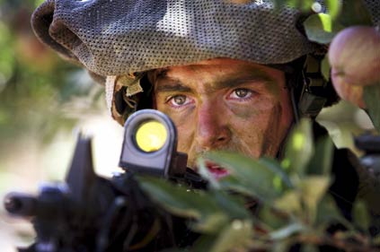 An Israeli soldier scouts the area near the Israel-Lebanon border July 20, 2006. Israel's Defence Minister Amir Peretz raised the possibility on Thursday of a ground offensive into Lebanon in its war against Hizbollah guerrillas firing rockets over the border.