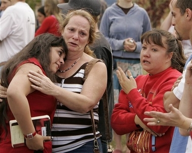 Platte Canyon High School student were reunited with parents and family after being evacuated from the school near Bailey, Colo., on Wednesday, Sept. 27, 2006. A middle-aged gunman walked into the high school of this mountain town Wednesday, shot and critically wounded a student and then killed himself after SWAT team members entered the building, authorities said. (AP